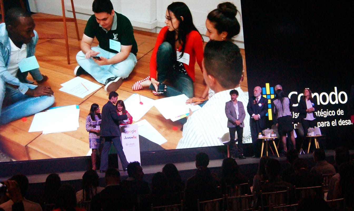 People gathered on stage at a Colnodo conference.