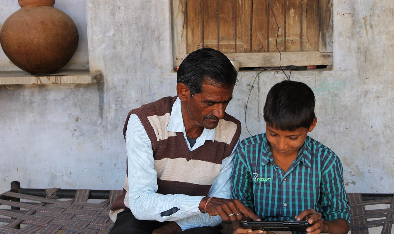 Parent and child access an offline lesson on a tablet.